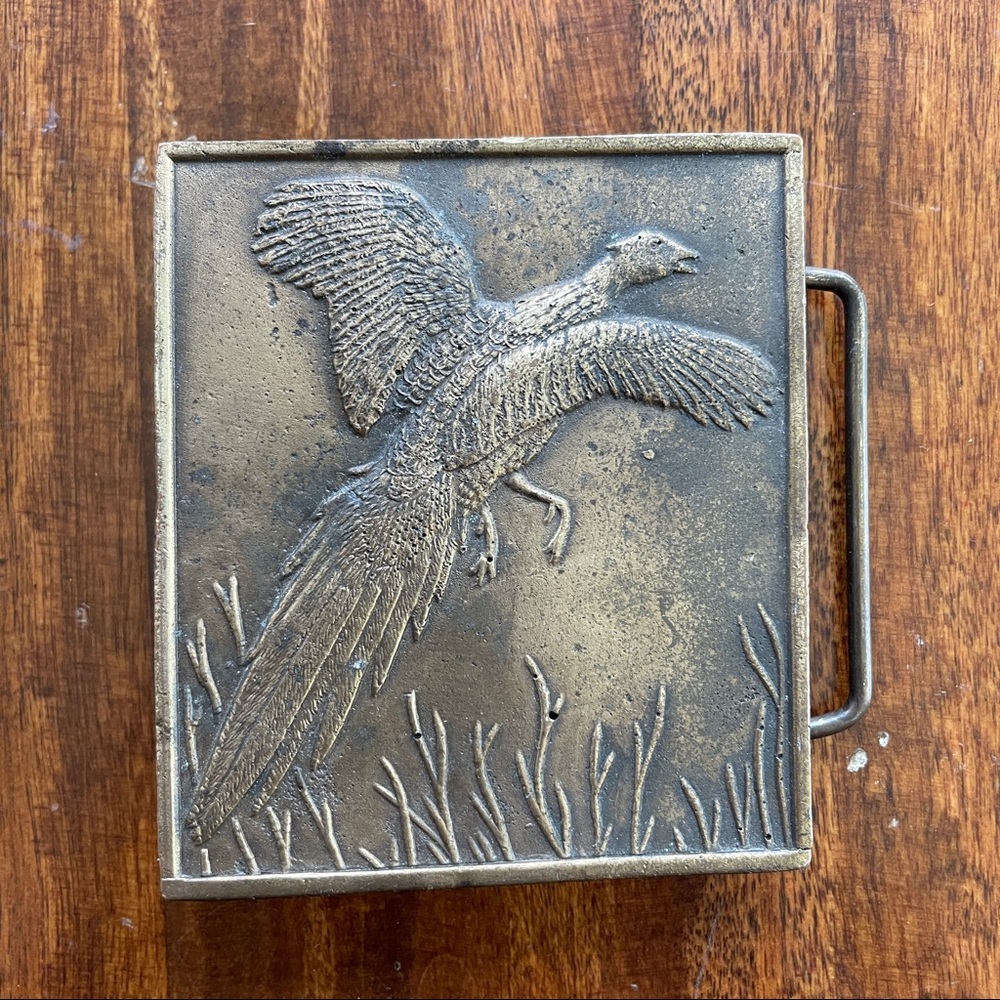 Vintage flying pheasant belt buckle in brass